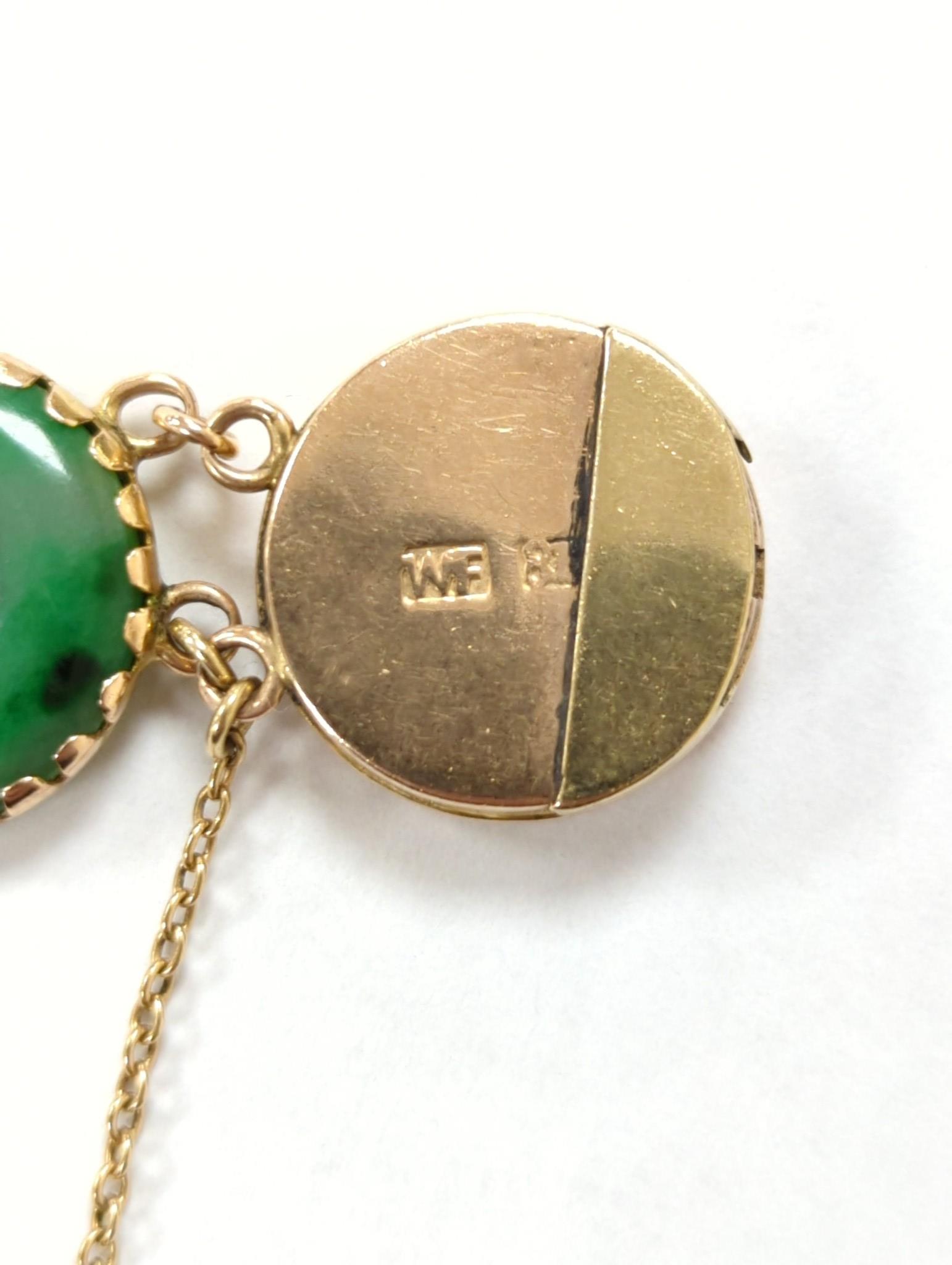 A Chinese yellow metal (stamped 18) and pierced eight stone jade disc set bracelet, with central Chinese characters, 16.5cm approx. gross weight 27.7 grams.